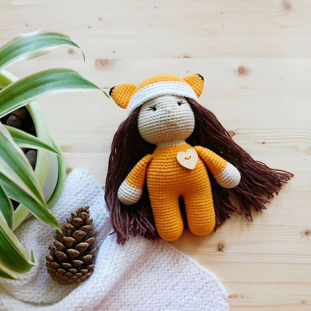 Amigurumi doll in fox costume