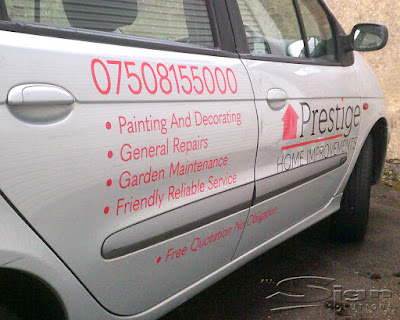 A photograph of the side of the car featuring the phone number in a red vinyl colour, lists of the bullet points: • Free Quotation No Obligation • Painting And Decorating • General Repairs • Garden Maintenance • Friendly Reliable Service. The logo has been applied to the other door, in red and black cut vinyl.