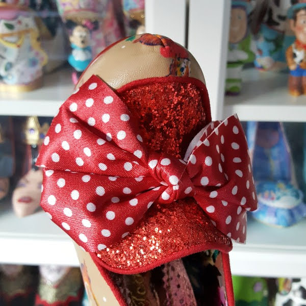 close up of red and white polka dot large bow on front of shoe