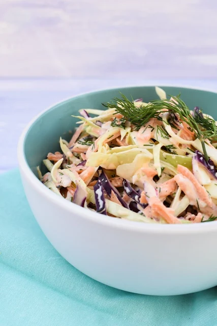 bowl of coleslaw with fresh herbs