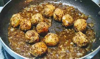 Stir frying manchurian balls with sauces for veg manchurian dry