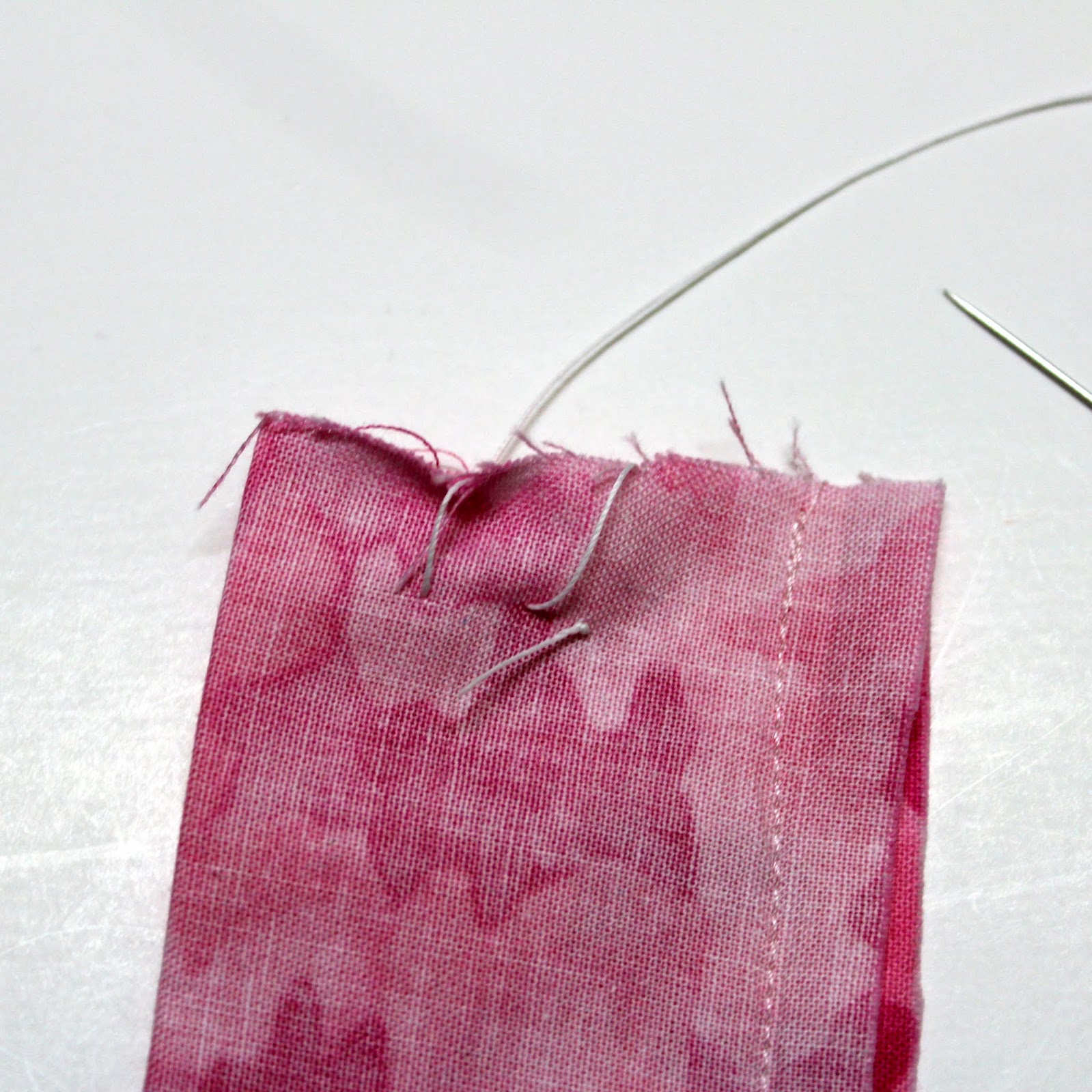 Now sew two stitches at one end of the tube, take care of sewing