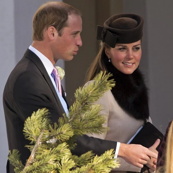 Kate wore a MaxMara dress and completed her look with a brown hat and drop-pearl earrings