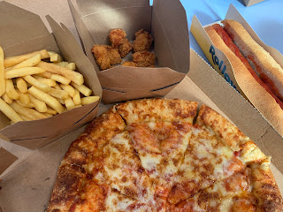 image of box of fries, a pizza a partially visible hot dog