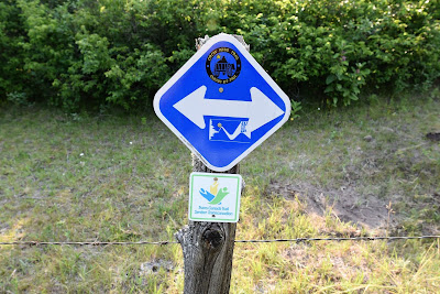 Crow Wing Trail arrow signage near St. Malo Manitoba.