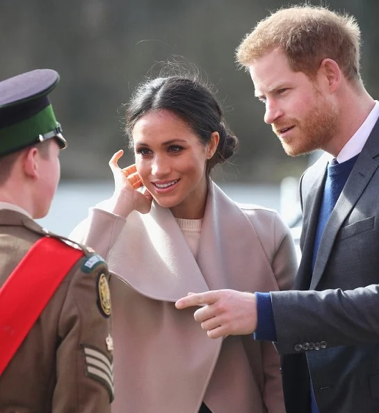 Meghan Markle wore Victoria Beckham cashmere sweater, Mackage Mia sand belted wool coat, Manolo Blahnik shoes and carried Charlotte Elizabeth bag