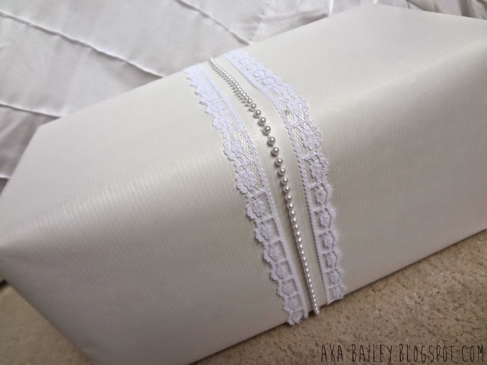 White paper gift wrap with white lace and pearls