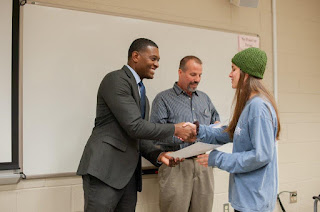 Secretary Regan presenting student Project WET certificate