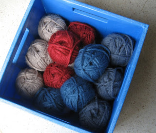 Top view of blue crate full of bulky weight yarn