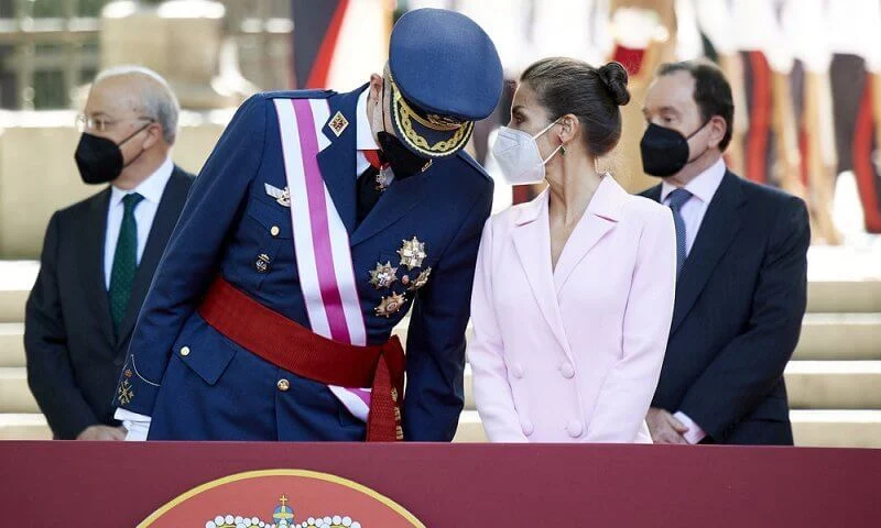 Queen Letizia wore a pink double breasted flared blazer dress coat, and pink clutch and pumps by Magrit. Tous jewelry earrings