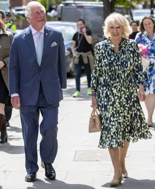 The Duchess of Cornwall wore a floral print silk dress by designer, Fiona Clare. Camilla carried for her Bottega Veneta bag