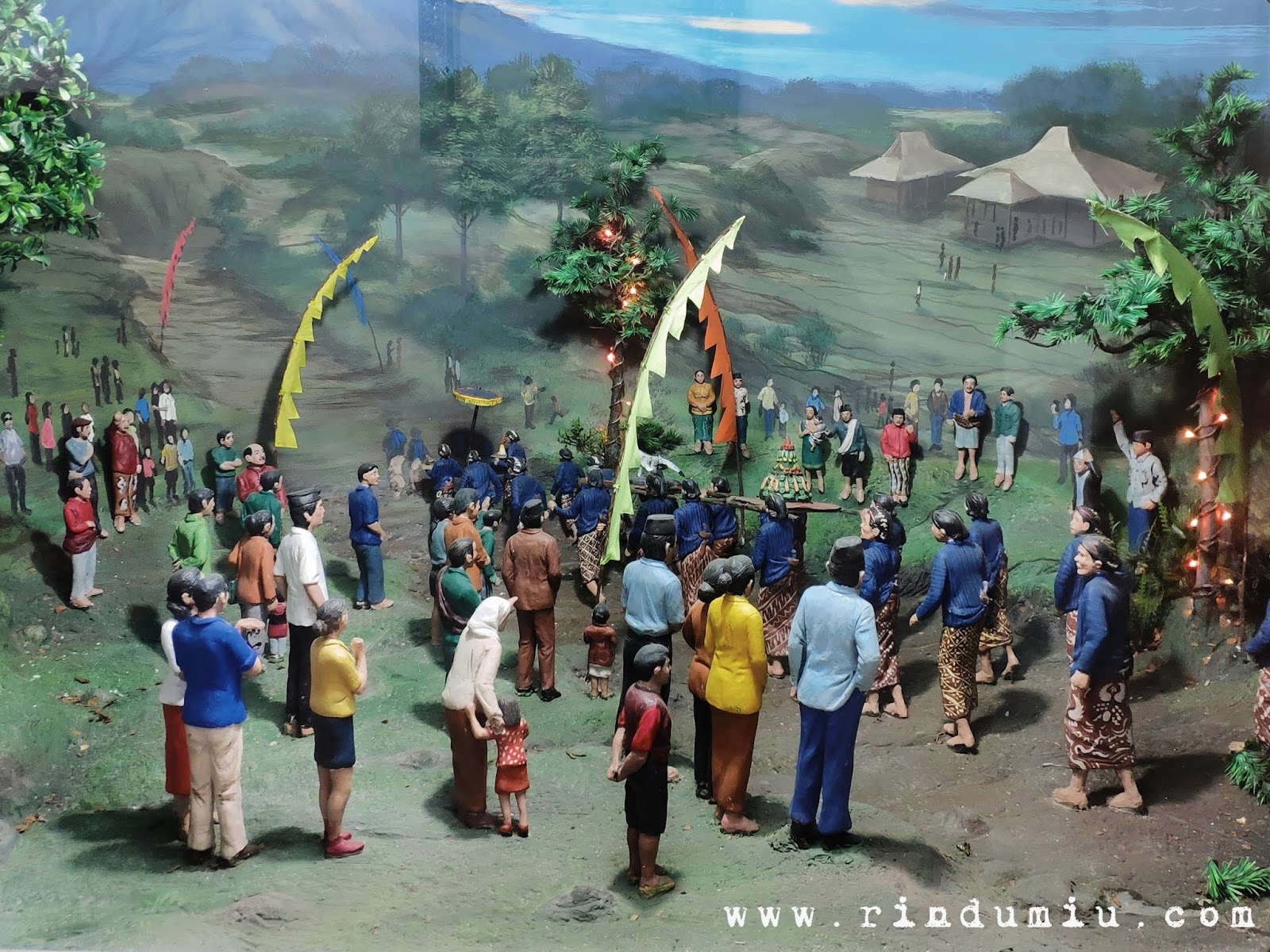 A diorama of Sedekah Gunung Merapi in which people walk in a long march bringing their alms and a cow's head in Hamong Wardoyo in Boyolali in the northeast of Jogja