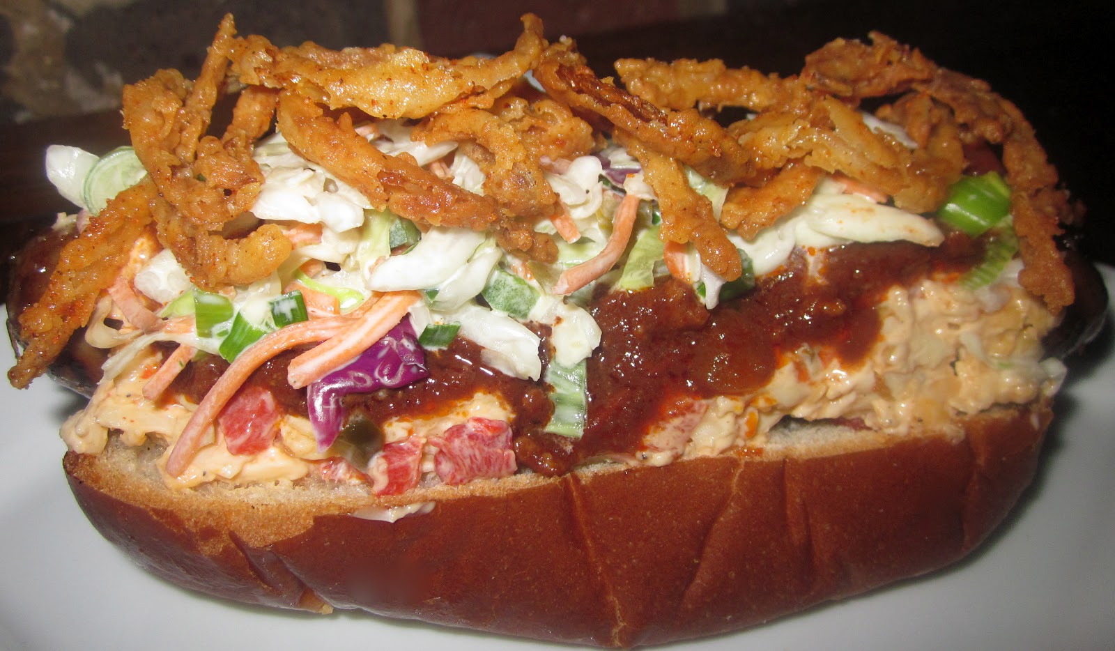 Haute + Heirloom ChiliCheeseSlaw Dogs with Beer Braised Brats topped