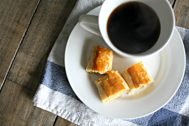 A plate of food and a cup of coffee, with Banket and Almond