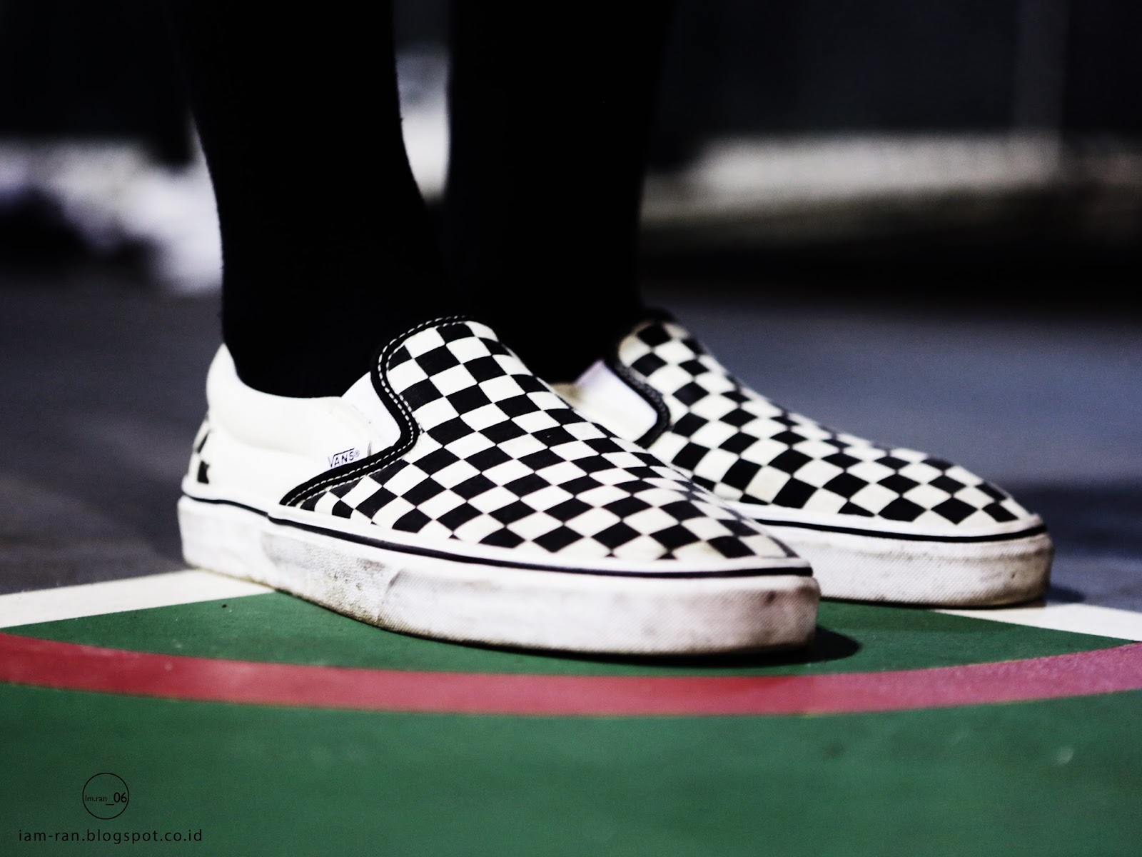 checkerboard slip on vans on feet