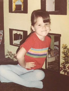 Me, age 5 or 6, in front of my homemade dollhouse