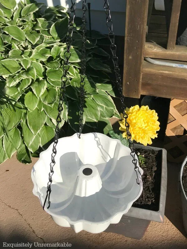 Bundt pan on chain hanging in garden