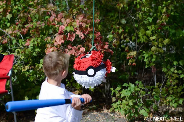 Breaking a paper mache pokeball pinata at a Pokemon themed birthday party