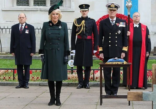The Duchess of Cornwall wore a green wool coat at Westminster Abbey. The Duchess in a recycled green coat, and a poppy facemask