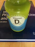 A bottle of vitamin D capsules, on Intermediate Physics for Medicine and Biology.