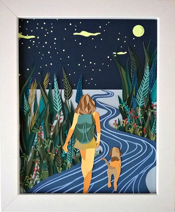 paper cut scene of a girl walking in the woods with her dog