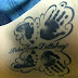 Hand and foot print tattoo on side body