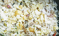 Mixing scrambled eggs with rice for cauliflower Manchurian fried rice recipe