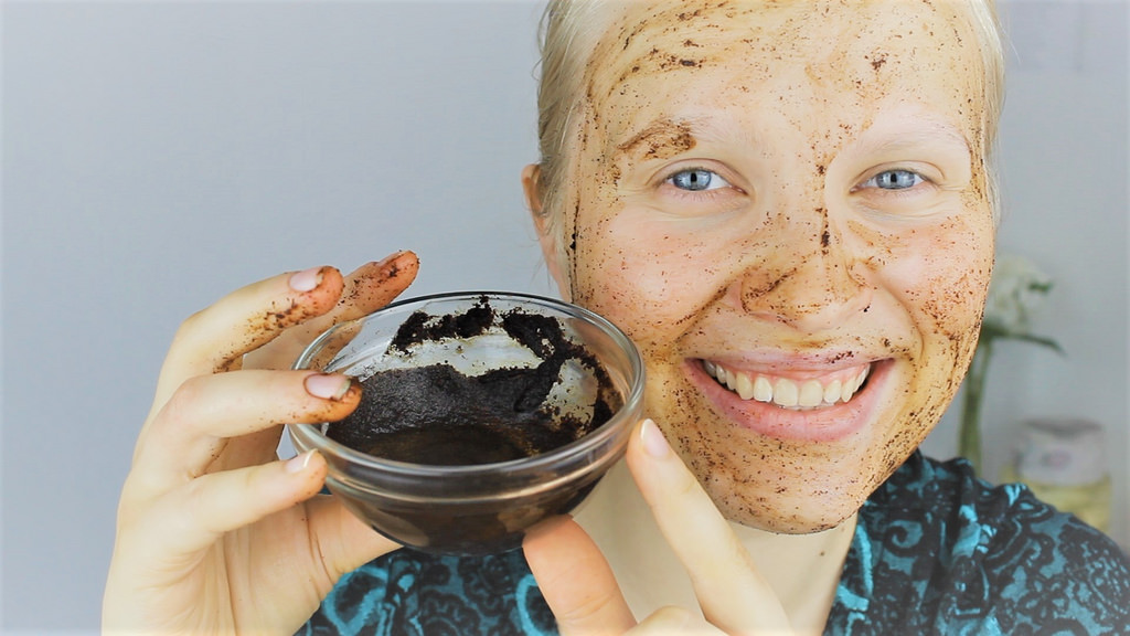 girl exfoliates her face with coffee