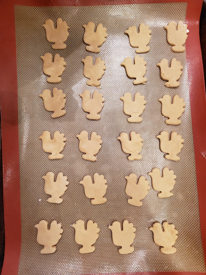 cookie dough made into turkey shapes with a cookie cutter