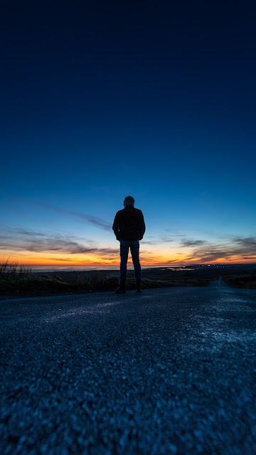 Wallpaper of a lonely man on the street at The Sunset Wallpaper of a lonely man on the street at The Sunset