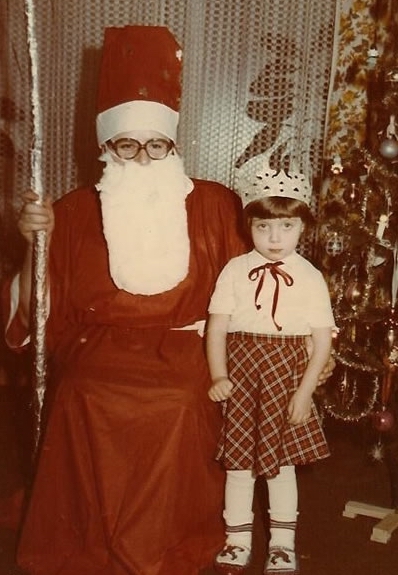 A less than enthusiastic little girl stands by a young looking Santa. c.1960s.   A Pleasant Christmas Story and other stories of Christmas Creepers. marchmatron.com