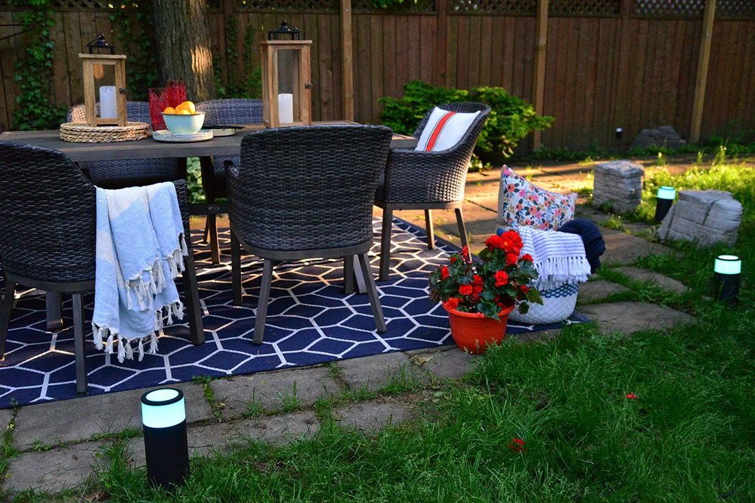outdoor backyard dining, summer entertaining tips, philips hue outdoor bollard and spotlights