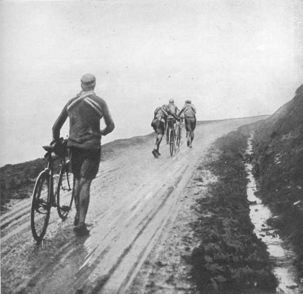 Thys,+Christophe,+Buysse+and+Garrigou+suffer+the+appalling+roads+of+the+time,+here+pictured+in+a+Pyreneen+stage..jpg