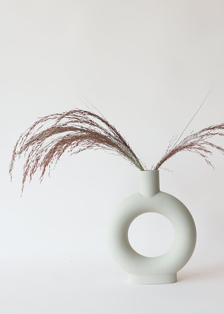 white modern donut vase with pampas grass stem