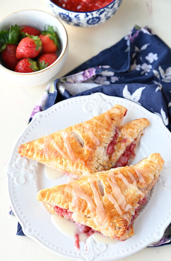 top view of a white plate with fresh strawberry turnovers