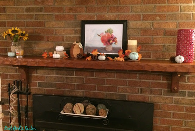 I enjoy mixing neutral shades with the traditional orange and yellows of fall to create a rustic fall mantel and wooden toolbox centerpiece.