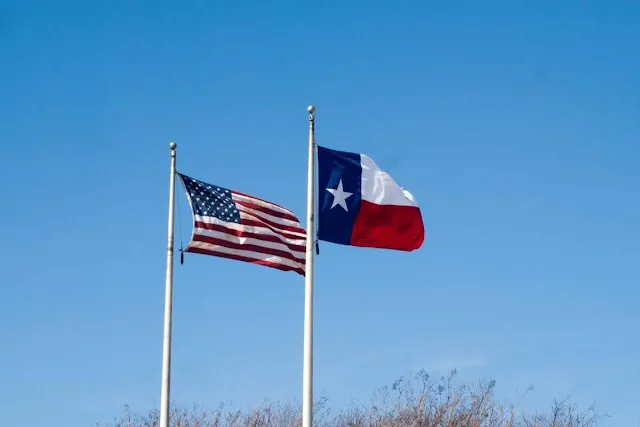 Houston to Austin Drive: American and Texas flags flying