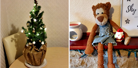 A mini decorated Christmas tree and a stuffed Monkey toy.