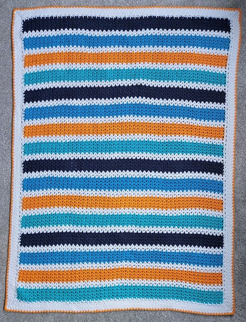 A cute stripy crochet v-stitch baby boy blanket
