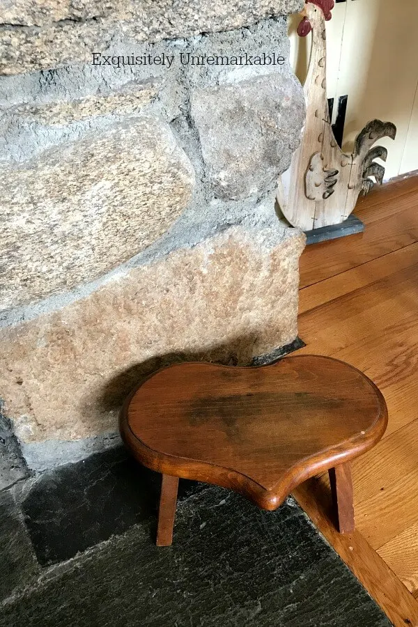 Wooden Heart Stool next to fireplace