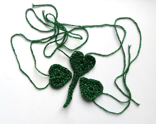 Three components: two heart-shaped leaves plus one heart-shape with a stem attached. Stitch the three elements together at the stem and heart points.