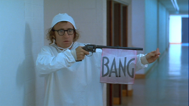 Woody Allen stealing the leader's nose with a fake gun in Sleeper