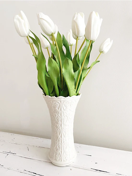 white tulips in white vase