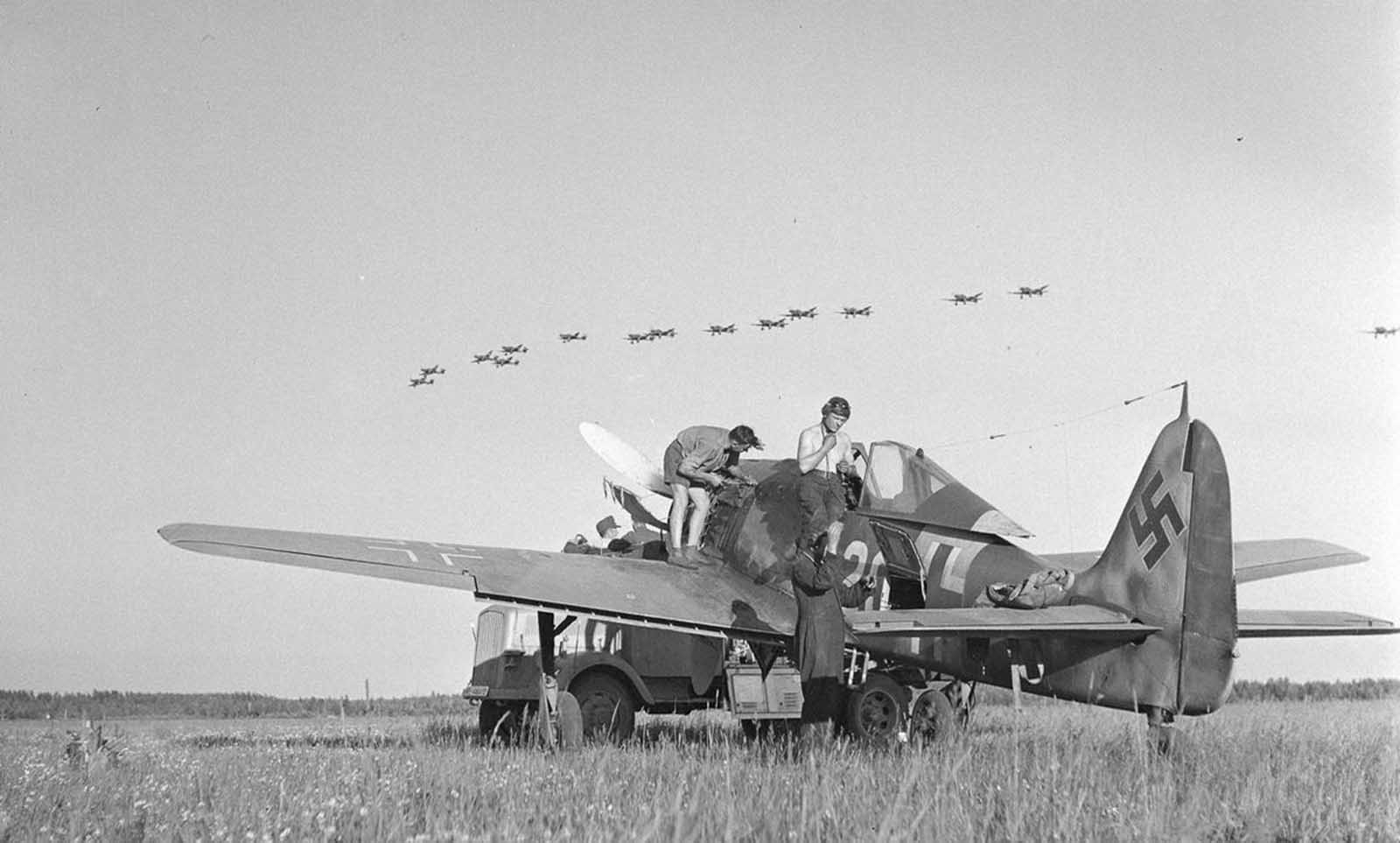 Stuka dive-bombers fly over, Immola, July 2, 1944.