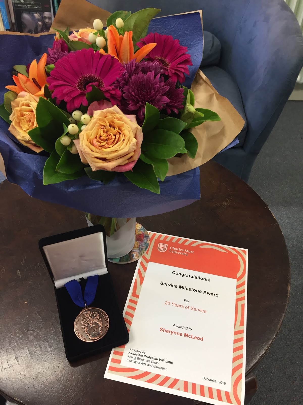 Speaking my languages 20 year service milestone medal from Charles