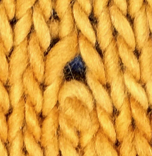 Dropped stitch in knitting, leaving a hole. TECHknitting.com