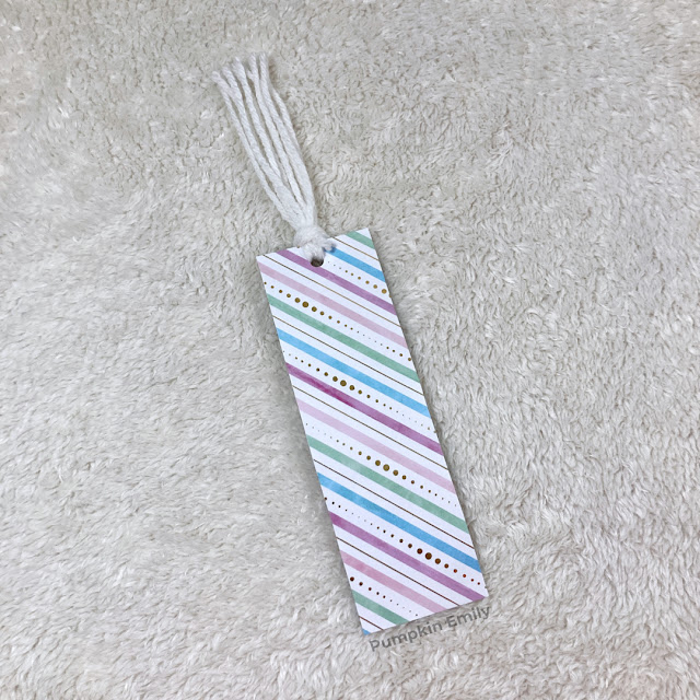 A double sided bookmark with yarn.