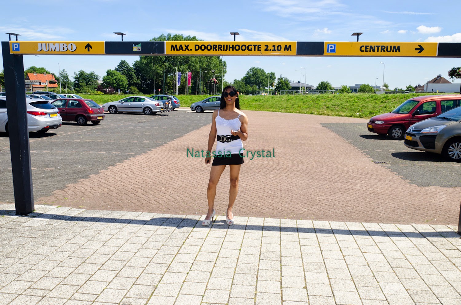 Natassia Crystal natcrys, short black skirt, white top, outside sunglasses