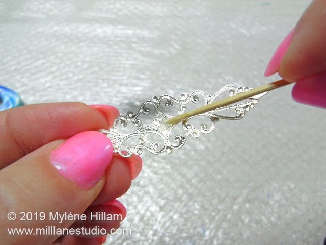 Applying 5-minute epoxy adhesive to the back of the filigree