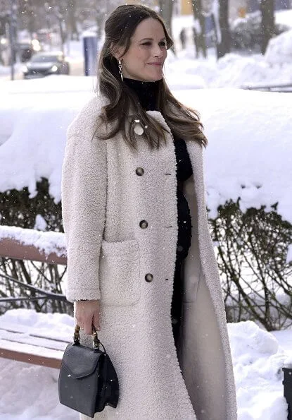 Pregnant Princess Sofia wore Chaos Queen earrings from Maria Nilsdotter Stockholm. 2nd day white coat faux fur. bamboo handle handbag